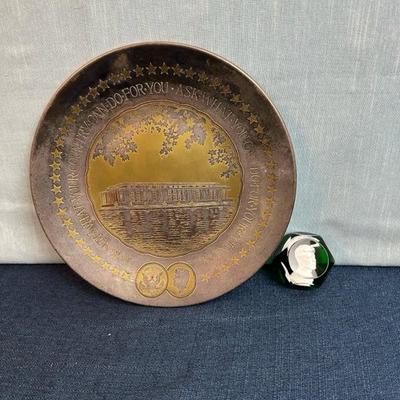 Lot No. 73, JFK metal Reed and Barton collectible plate 11 inches across and JFK paperweight