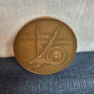 Lot 76, USS, John F Kennedy belt buckle + 2 paperweight coins