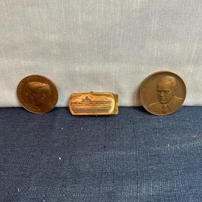 Lot 76, USS, John F Kennedy belt buckle + 2 paperweight coins