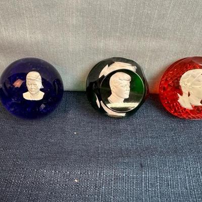 Lot 81 Kennedy paperweights, three glass, one acrylic