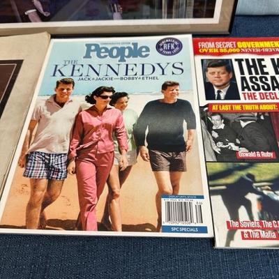 Lot 108  Framed photograph of John F Kennedy Jr. and Jacqueline Kennedy. Also several magazines.