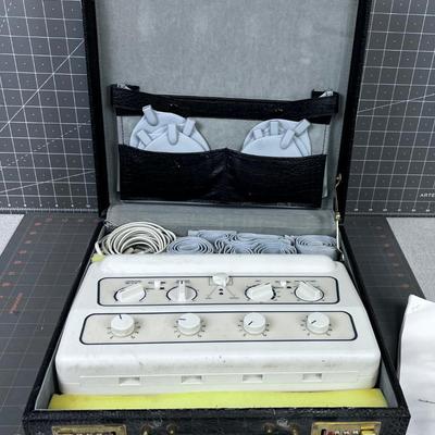 Tens Pain Relief Machine in CASE, comes in a Black Alligator Skin Faux Case. 