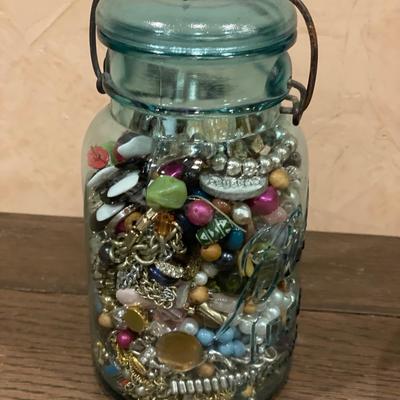 Vintage Blue Ball jar filled with miscellaneous jewelry pieces