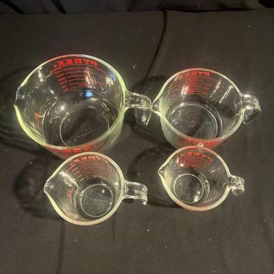 Four Pyrex Measuring Cups (K-MG)