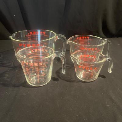 Four Pyrex Measuring Cups (K-MG)