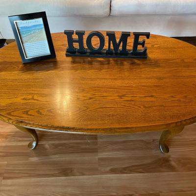 Wood oval coffee table with HOME decor