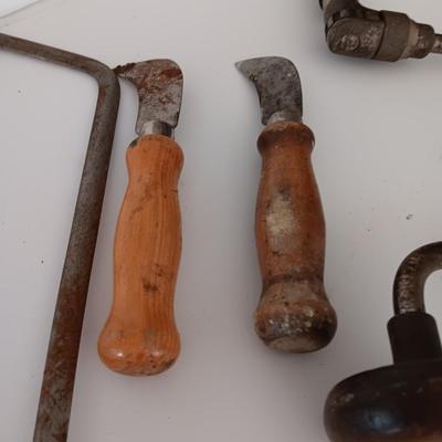 Variety of vintage hand tools - wooden handles - saw - drill - draw knife