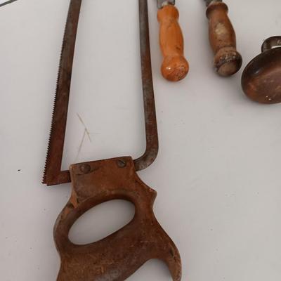 Variety of vintage hand tools - wooden handles - saw - drill - draw knife