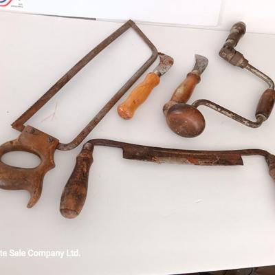 Variety of vintage hand tools - wooden handles - saw - drill - draw knife