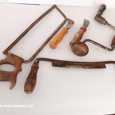 Variety of vintage hand tools - wooden handles - saw - drill - draw knife