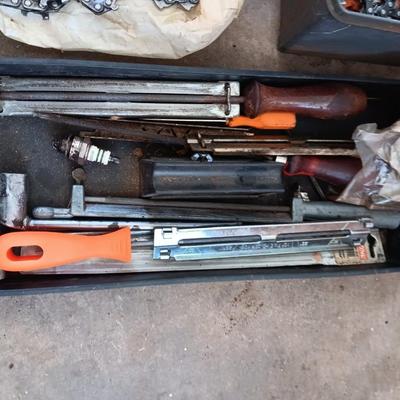 Plastic toolbox full of Chainsaw tools with Jug of bar and saw chain lubricant and a gas can