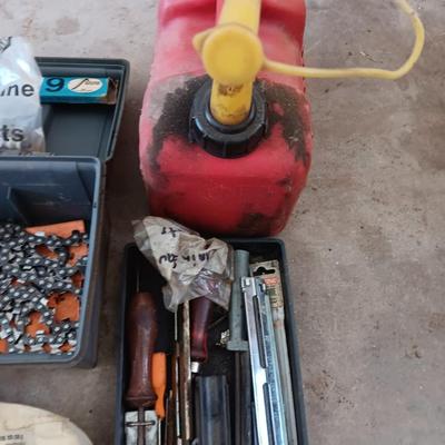 Plastic toolbox full of Chainsaw tools with Jug of bar and saw chain lubricant and a gas can