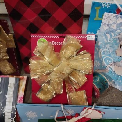 GIFT BAGS, BIG BOWS, GIFT BOXES AND A ROLL OF RIBBON