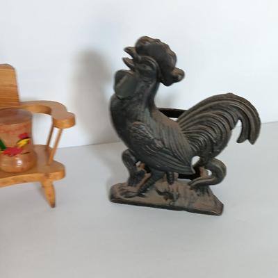 Cast Iron Rooster napkin holder with chicken theme salt & pepper on a bench.
