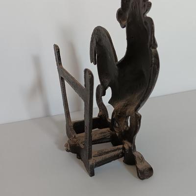 Cast Iron Rooster napkin holder with chicken theme salt & pepper on a bench.