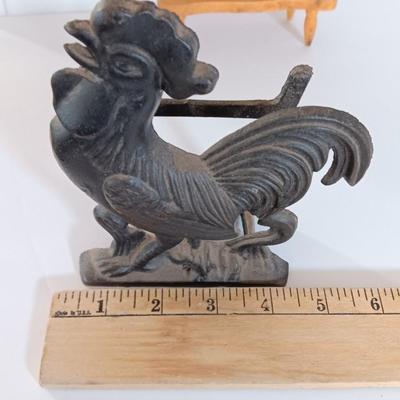 Cast Iron Rooster napkin holder with chicken theme salt & pepper on a bench.