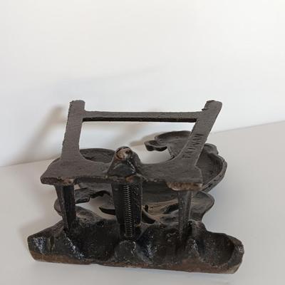 Cast Iron Rooster napkin holder with chicken theme salt & pepper on a bench.