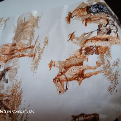 Vintage wooden covered wagon with horse team and wild west cowboy fabric