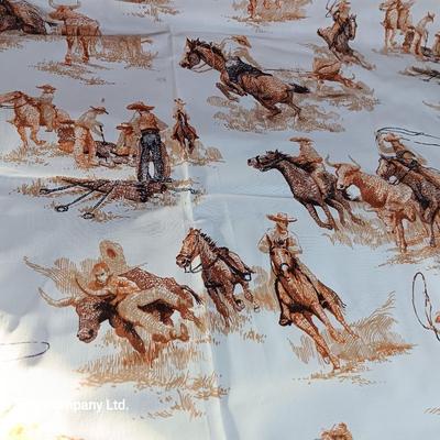 Vintage wooden covered wagon with horse team and wild west cowboy fabric