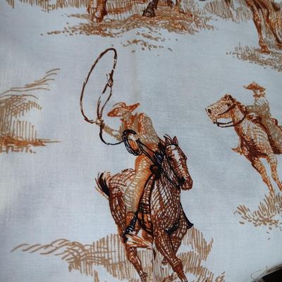 Vintage wooden covered wagon with horse team and wild west cowboy fabric