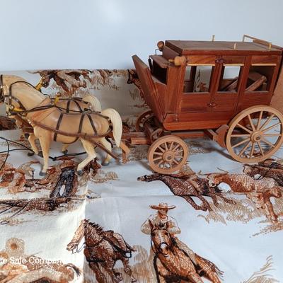 Vintage wooden covered wagon with horse team and wild west cowboy fabric