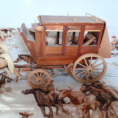 Vintage wooden covered wagon with horse team and wild west cowboy fabric