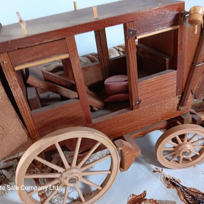 Vintage wooden covered wagon with horse team and wild west cowboy fabric