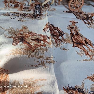 Vintage wooden covered wagon with horse team and wild west cowboy fabric