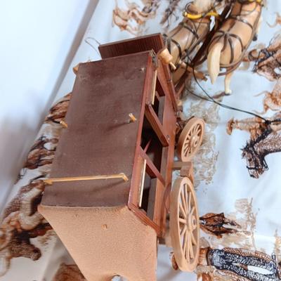 Vintage wooden covered wagon with horse team and wild west cowboy fabric