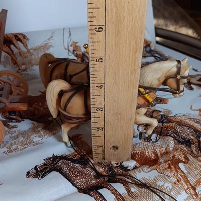 Vintage wooden covered wagon with horse team and wild west cowboy fabric