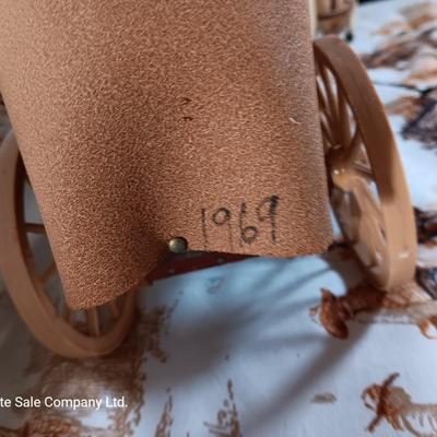 Vintage wooden covered wagon with horse team and wild west cowboy fabric