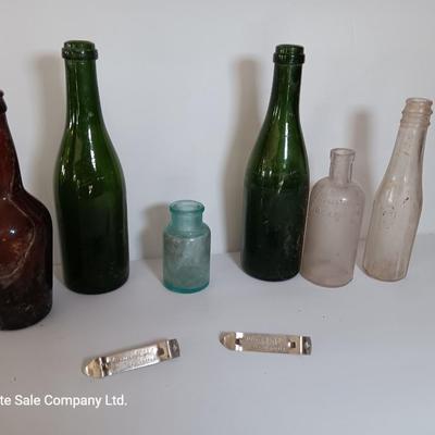 Antique glass bottles and two bottle openers