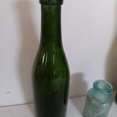 Antique glass bottles and two bottle openers