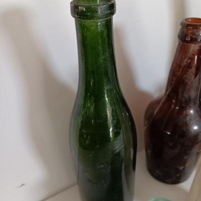 Antique glass bottles and two bottle openers