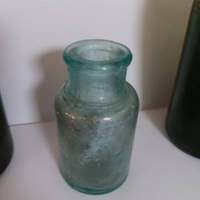 Antique glass bottles and two bottle openers