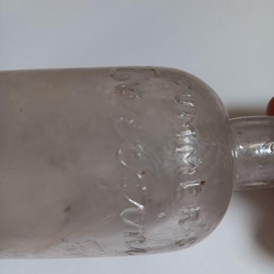 Antique glass bottles and two bottle openers