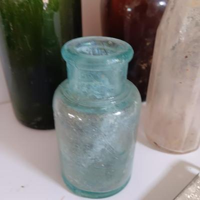 Antique glass bottles and two bottle openers