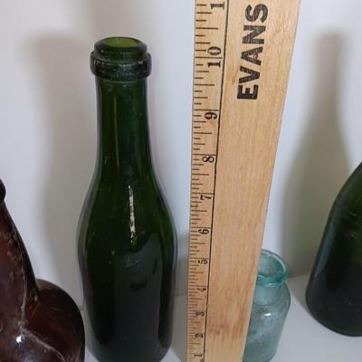 Antique glass bottles and two bottle openers