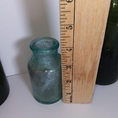 Antique glass bottles and two bottle openers