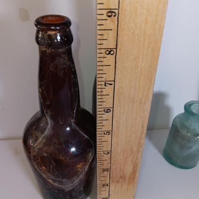 Antique glass bottles and two bottle openers