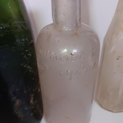 Antique glass bottles and two bottle openers