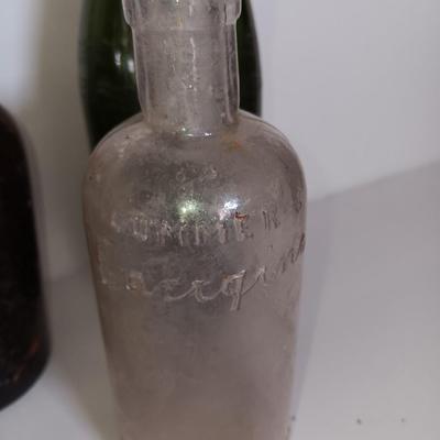 Antique glass bottles and two bottle openers