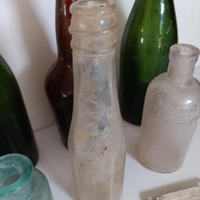 Antique glass bottles and two bottle openers