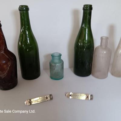Antique glass bottles and two bottle openers