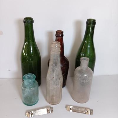 Antique glass bottles and two bottle openers