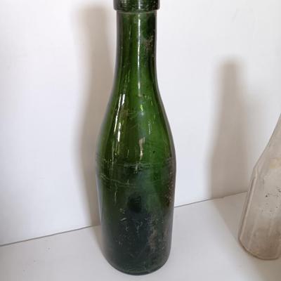 Antique glass bottles and two bottle openers