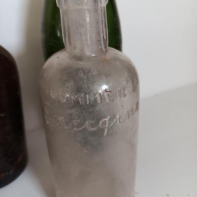 Antique glass bottles and two bottle openers