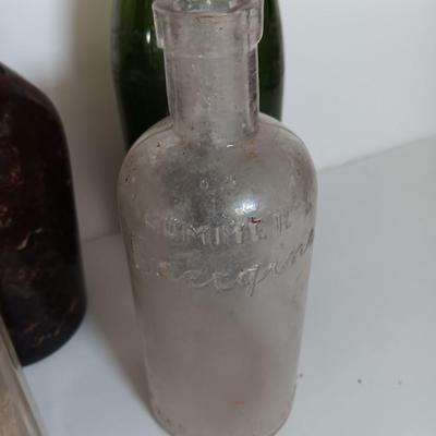 Antique glass bottles and two bottle openers