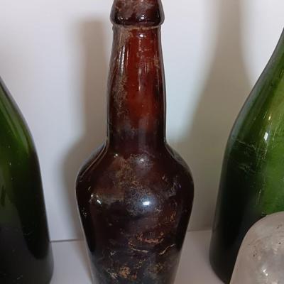 Antique glass bottles and two bottle openers