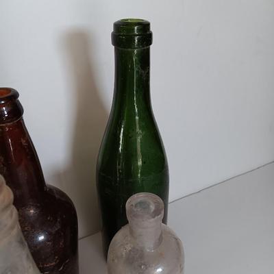 Antique glass bottles and two bottle openers